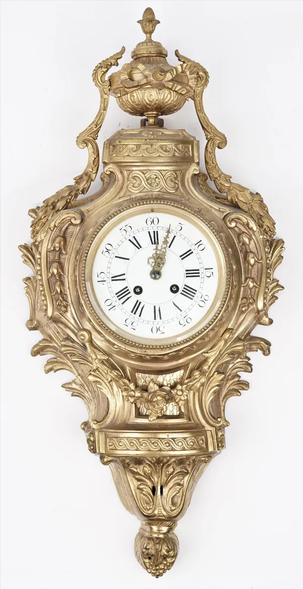 An 18th century style gilt metal cartel clock, 20th century with urn finial over a foliate cast case and white enamel dial enclosing a two train movem