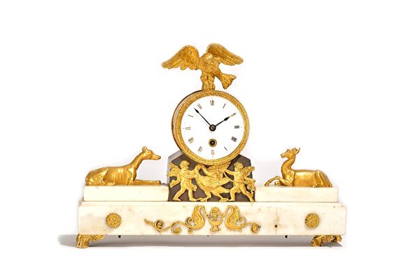 A Regency Ormolu and patinated bronze mounted white marble timepiece mantel clock, circa 1820, the drum case with eagle surmount, flanked by greyhound