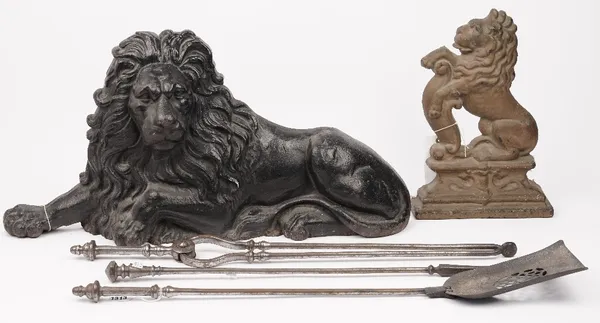 A set of three Georgian steel fire irons, 76cm, a Victorian black painted cast iron 'Lion' form door stop, 72cm wide, and a gilt painted cast iron 'li