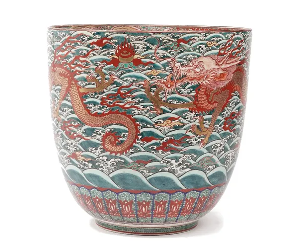 A modern Japanese porcelain jardiniere, decorated with a red dragon chasing a flaming pearl against a green ocean ground, red printed mark to base, 33