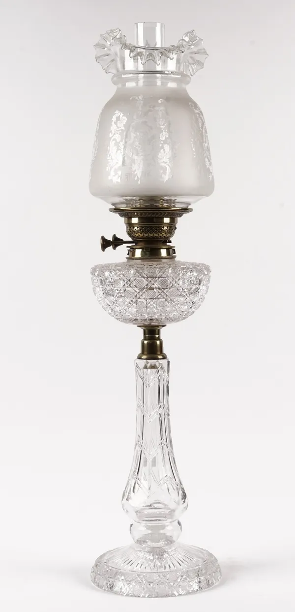 A Victorian cut glass oil lamp base, with brass mounts and later etched glass shade, 76cm high.