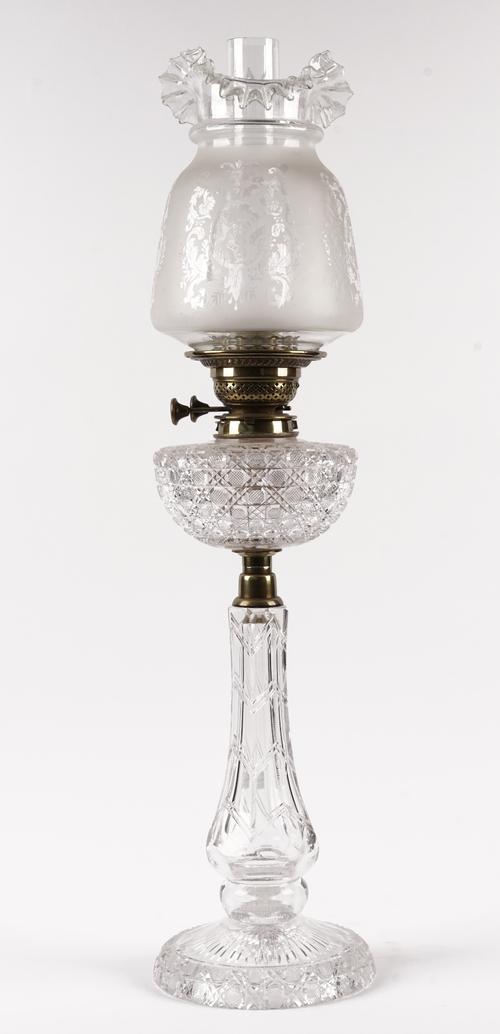 A Victorian cut glass oil lamp base, with brass mounts and later etched glass shade, 76cm high.