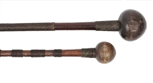 An African knobkerrie, the shaft bound with sections of two tone metal wire, 68cm long, together with another metal wire bound knobkerrie, 59cm long,