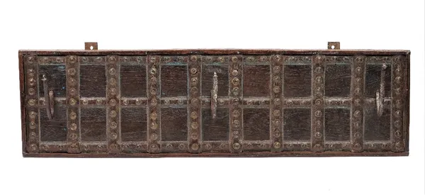 A set of three Middle Eastern metal wall hooks, mounted on a hardwood rectangular wall plaque, with further metal mounts and a distressed finish, 89cm