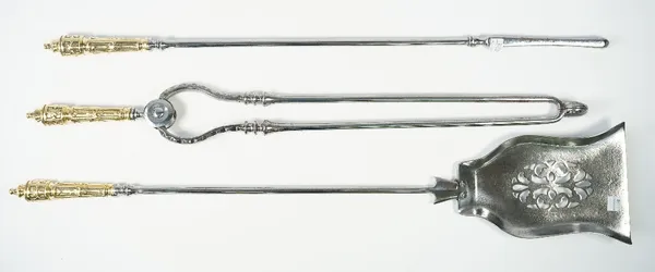 A set of Victorian polished steel fire irons, with brass handles, and a pierced shovel plate, 78cm, (3).