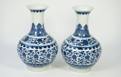 A pair of modern Chinese style blue and white porcelain vases, each foliate decorated against a baluster ground, printed mark to base, 30.5cm high, (2