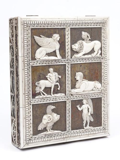 An early 19th century rectangular wooden box, with relief carved ivory panels to the hinged lid depicting six anthropomorphic figures within a beaded