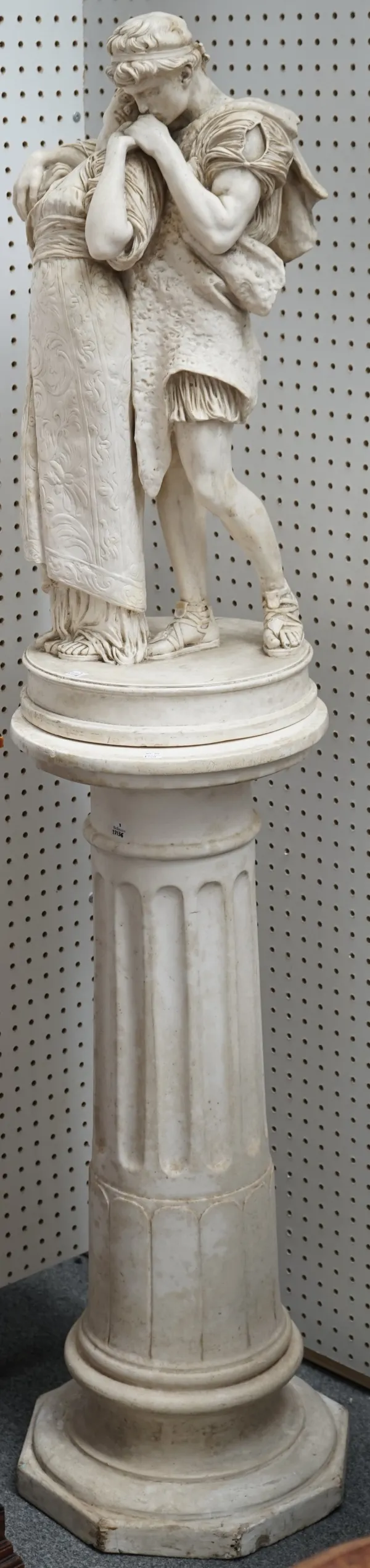 A 19th century style plaster figural sculpture on a fluted pedestal detailed to the rear, modelled by G.B. AMENCOLA from the picture by Frederick Leig