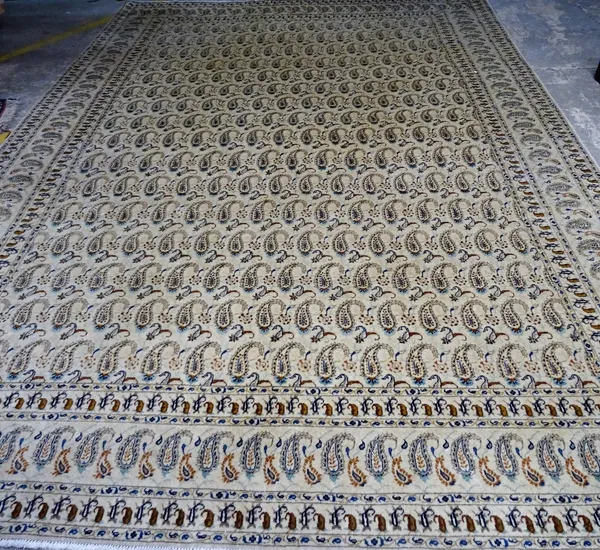 An Isfahan carpet, Persian, the ivory field with an all over pattern of rows of elongated botehs; a complementary border, 365cm x 255cm.