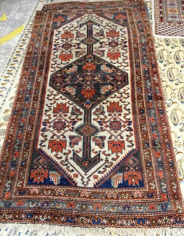 A Hamadan rug, Persian, the ivory field with a diamond medallion; all with a stylised herate design, corner sprandrels; three minor floral borders, 19