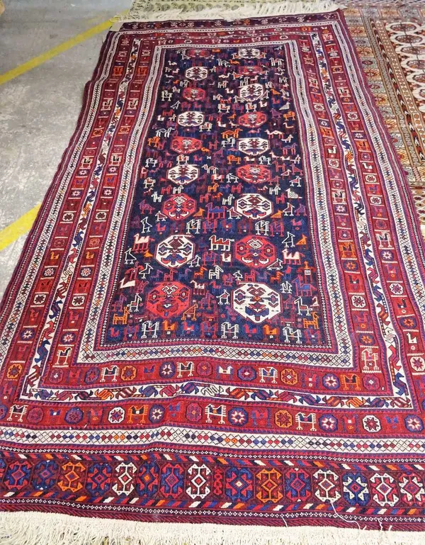 A South Persian soumak rug, the dark indigo field with ivory and madder boteh, birds, camels and goats; two bird section borders, end bands, 224cm x 1