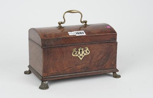 A mid-18th century mahogany dome top tea caddy on gilt metal paw feet, 27cm wide x 16cm high.