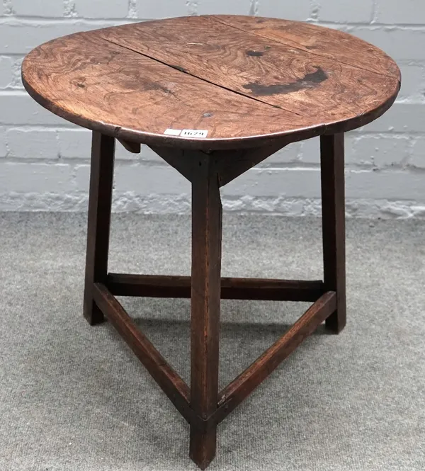 A late 18th/early 19th century elm and oak cricket table, with perimeter stretcher, 54cm diameter x 53cm high.