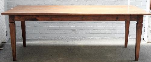 A early 19th century French farmhouse kitchen table, the triple plank top on later tapering square supports, 90cm x 219cm long.