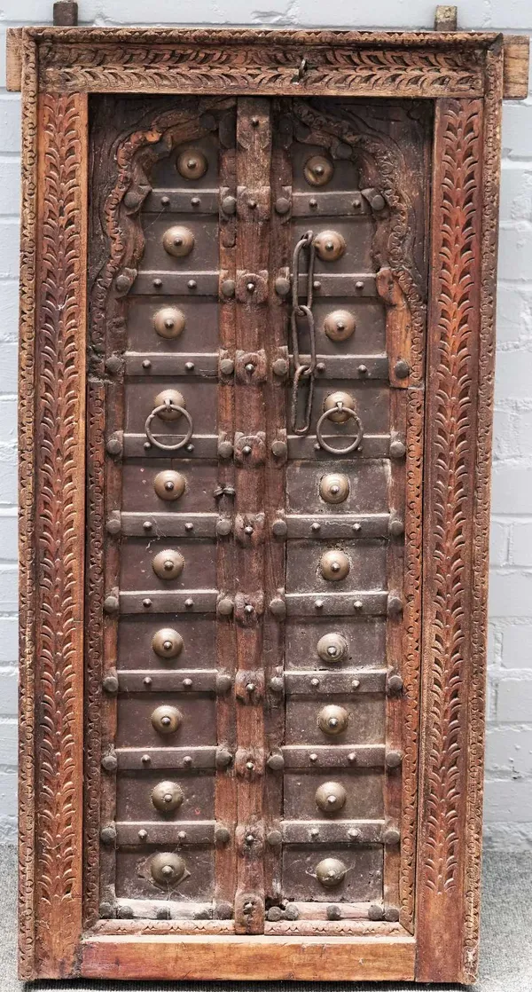 A 19th century Eastern carved hardwood window, with double arch panel doors, 61cm x 119cm high.