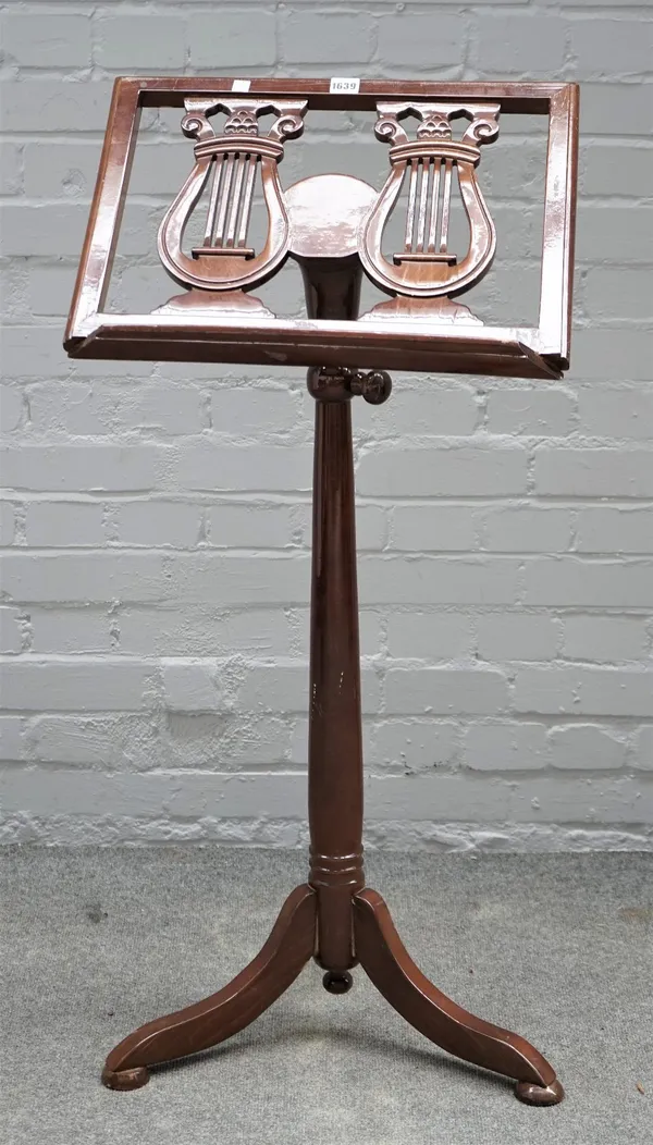 A Continental mahogany height adjustable sheet music stand, with double lyre decoration and tripod base, 51cm wide.