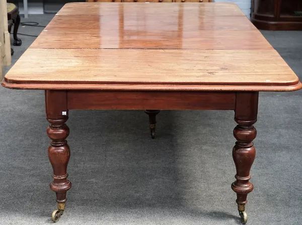 A 19th century mahogany extending dining table, on turned supports with two extra leaves, 140cm wide x 138cm long. 248cm long extended.