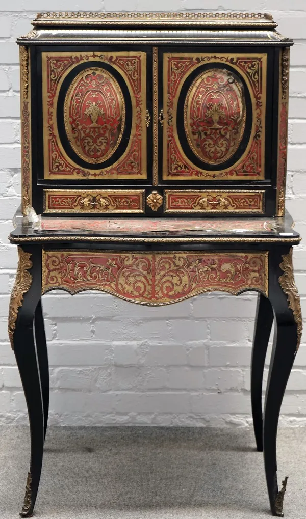 A 19th century gilt metal mounted ebonised boulle work writing desk, the pair of raised oval panel doors over a pair of short drawers, the serpentine