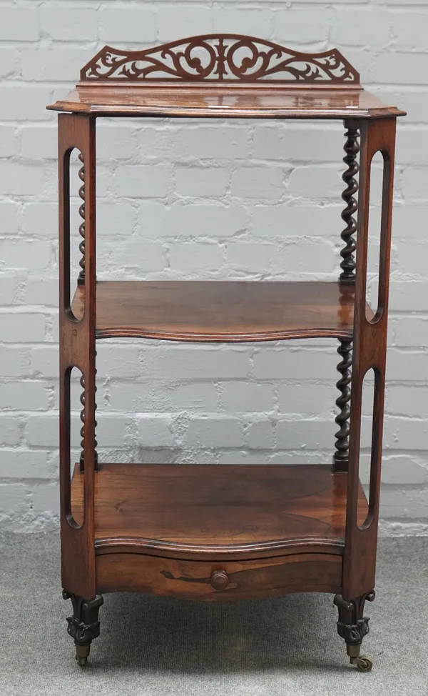 A Victorian rosewood serpentine three tier whatnot, with single drawer base, 59cm wide x 109cm high.