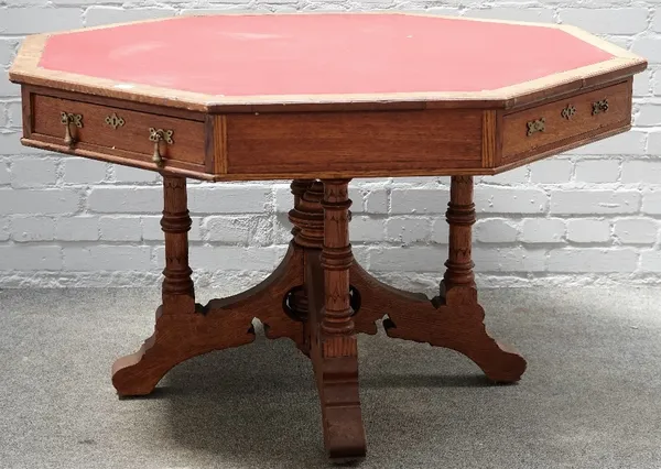 A Victorian Gothic revival oak octagonal centre table, with four dummy and four true drawers on turned columns and four downswept supports, 133cm wide