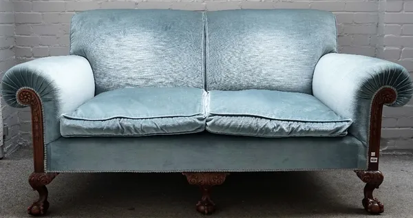 A Chippendale revival roll arm sofa with carved mahogany frame, on claw and ball feet, 190cm wide x 98cm high.