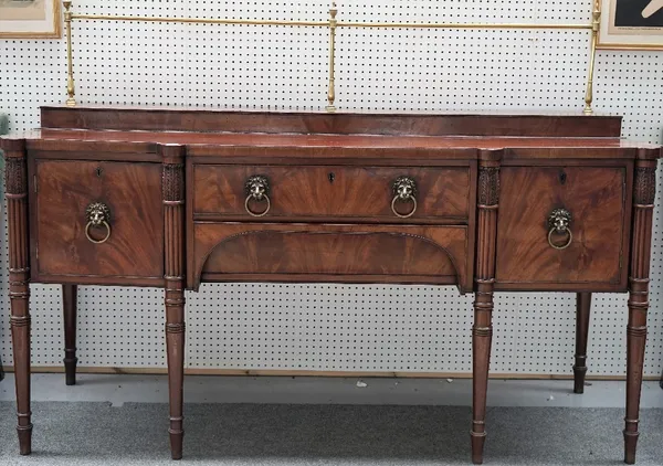 A late George III mahogany sideboard, the brass galleried back over a pair of drawers and cupboards, on turned supports, 194cm wide x 140cm high.