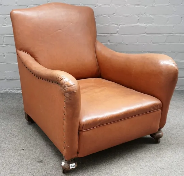 An early 20th century brown leatherette upholstered easy armchair, on turned beech supports, 72cm wide x 78cm high.