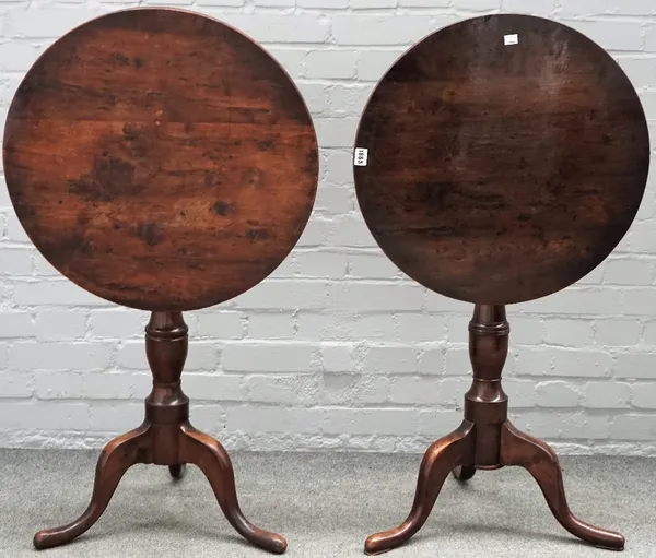 A near pair of George III style yew wood pedestal tables, incorporating period elements, the circular tilt-tops on vase turned pillars and tripod base