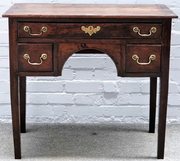 A mid-18th century oak lowboy with three drawers about the arch frieze, on square supports, 87cm wide x 78cm high.