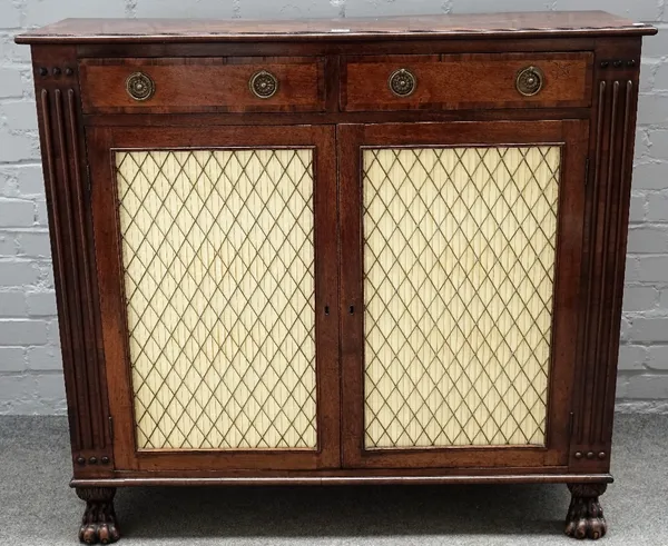 A Regency mahogany side cabinet with a pair of drawers over grille doors, on carved paw feet, 113cm wide x 103cm high.