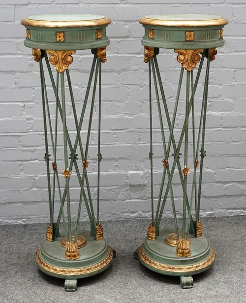 A pair of 18th century style parcel gilt green painted circular torchere stands, with open metal frames on scroll feet, 36cm diameter x 113cm high.