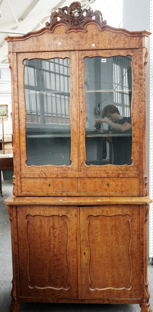 A 19th century Continental display cabinet/cupboard with a pair of glazed doors over a pair of drawers and cupboards, 104cm wide x 217cm high.