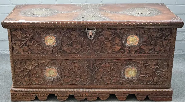 A 19th century Indian brass and copper mounted, carved hardwood trunk with shaped plinth, 105cm wide x 53cm high.