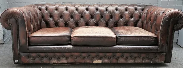 A brown leather button back Chesterfield sofa, with studded decoration, 210cm wide x 70cm high.