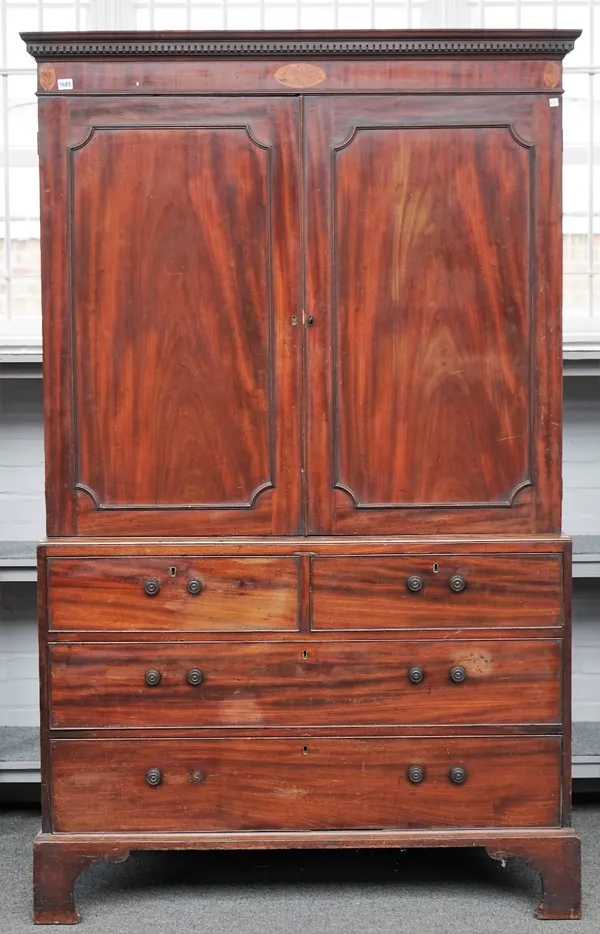 A George III mahogany linen press, the pair of panel doors over two short and two long drawers, on bracket feet, 126cm wide x 200cm high.