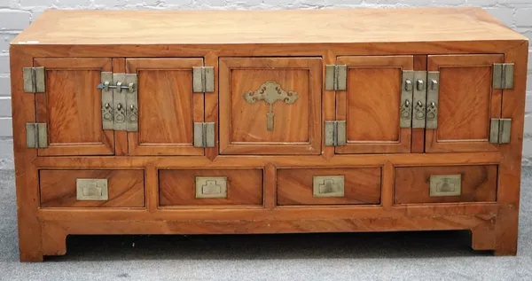 A 19th century Chinese camphor wood low cabinet, with five cupboards over four drawers, on bracket feet, 141cm wide x 63cm wide.   A/S