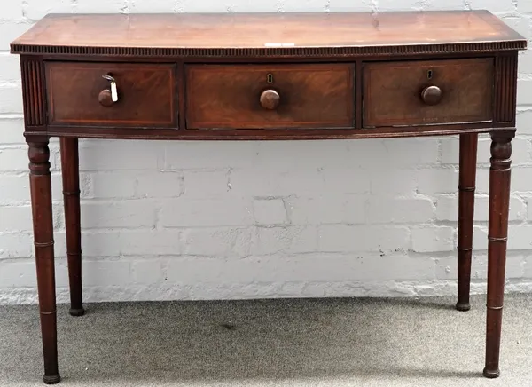 A Regency mahogany satinwood crossbanded boxwood strung bowfront side table, with three frieze drawers, on ring turned cylindrical tapering legs, 107c