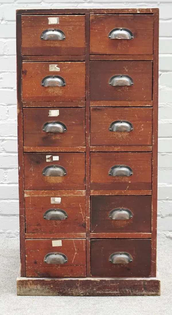 A 20th century pine bank of twelve drawers, on a pine base, 57cm wide x 111cm high.