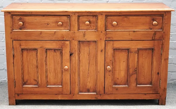 A stained pine dresser base with three drawers over a pair of cupboards, 135cm wide x 81cm high.