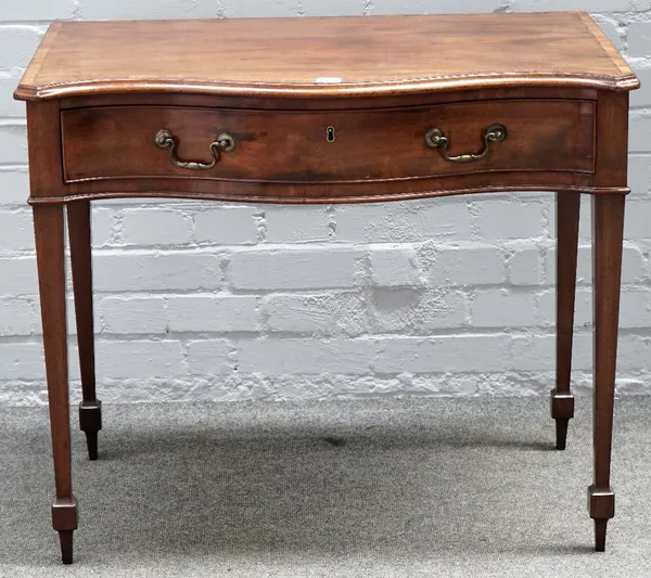 A George III inlaid mahogany, serpentine single drawer writing desk, on tapering square supports, 85cm wide x 72cm high.