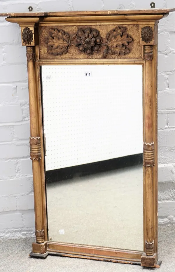 A Regency gilt framed pier glass, with floral moulded frieze and turned columns, 62cm wide x 94cm high.