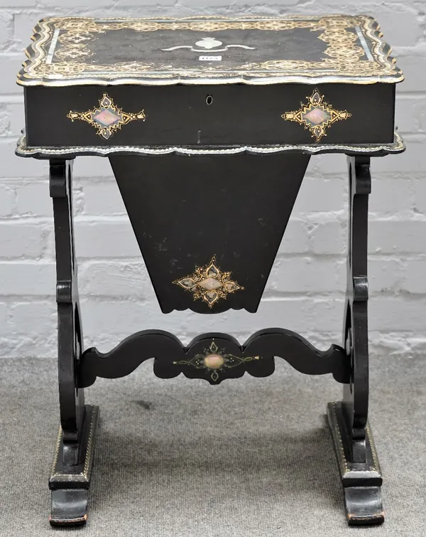 A Victorian mother-of-pearl, gilt decorated black lacquer sewing table, with fitted interior on trestle supports, 55cm wide x 71cm high.