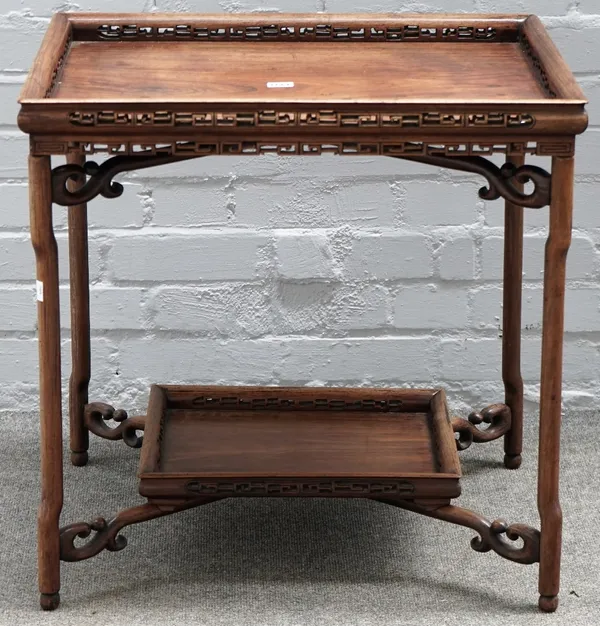 A Chinese rosewood folding table, late 19th century, the rectangular tray top with key pattern carved and pierced ogee gallery, on shaped rounded legs