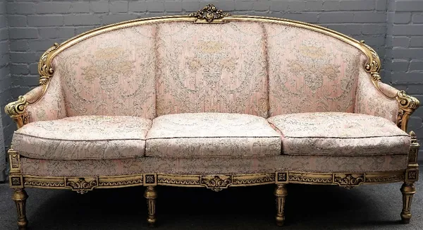 An 18th century Italian style gilt framed three piece suite to comprise; a sofa, 205cm wide x 113cm high, and a pair of matching armchairs, 84cm wide