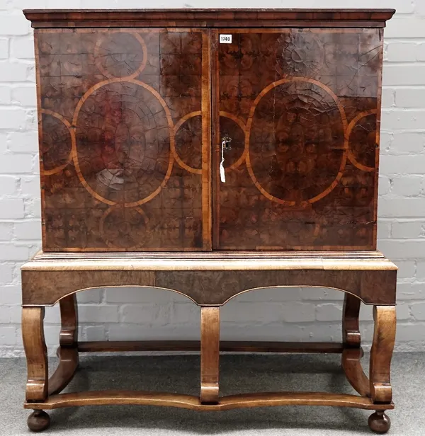 A late 17th century walnut and oyster walnut veneered cabinet, with isometric crossbandings, fitted with an arrangement of thirteen drawers, four behi