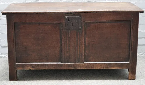 A 17th century oak coffer, with plank top over double panel front, 118cm wide x 61cm high.