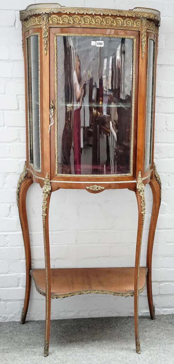 An early 20th century French gilt metal mounted vitrine, the marble top over single door, on slender cabriole supports, 75cm wide x 160cm high.