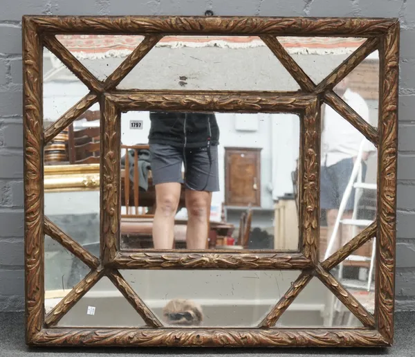 A 20th century gilt framed wall mirror, with segmented concave frame, 89cm wide x 77cm high.