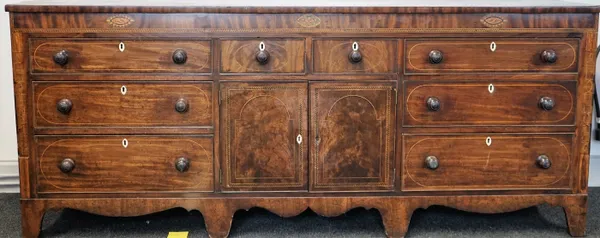 A large 18th century inlaid mahogany side cabinet with a pair of drawers over cupboards, flanked to each side by three long graduated drawers, 217cm w