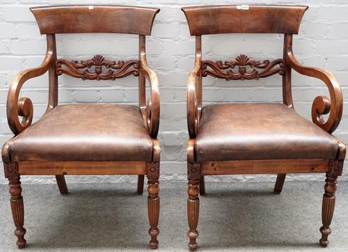 A pair of early Victorian style mahogany carver chairs, with carved waist rail on reeded supports, 58cm wide x 90cm high.